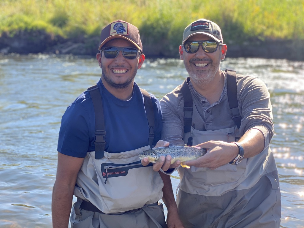 A. Jimmy Garza III with a trout on the river